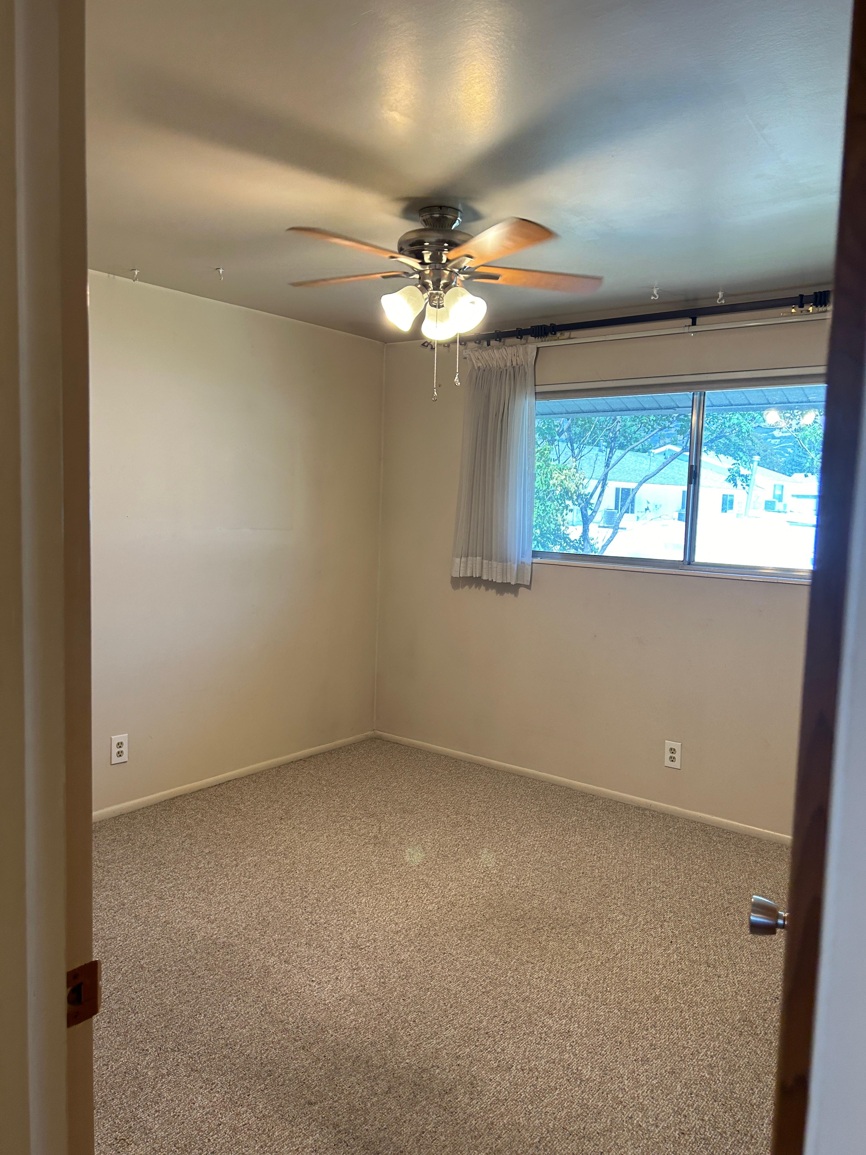 Room featuring neutral-toned walls and plush carpeting