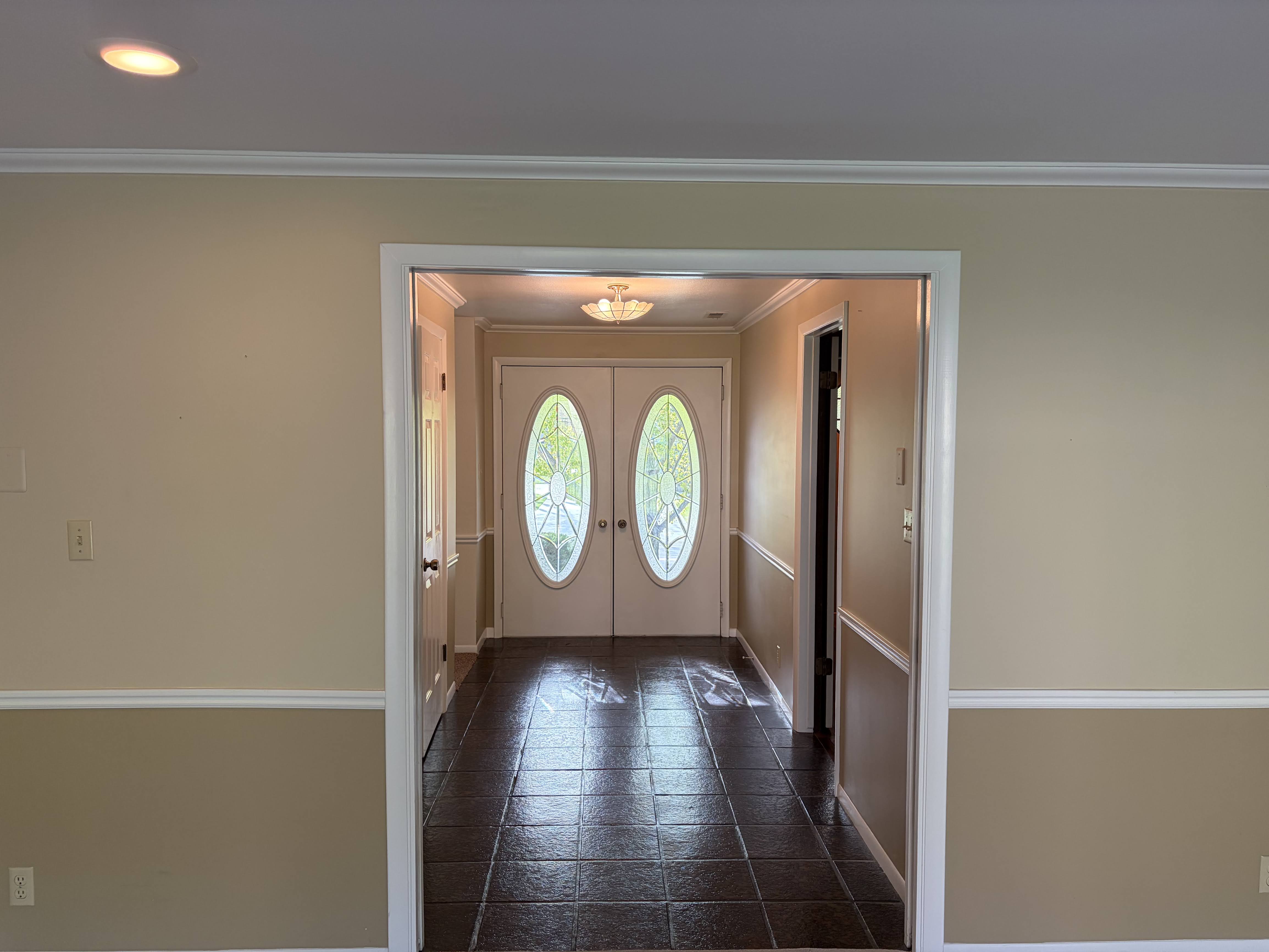 Doorway to outside with crown molding and french doors
