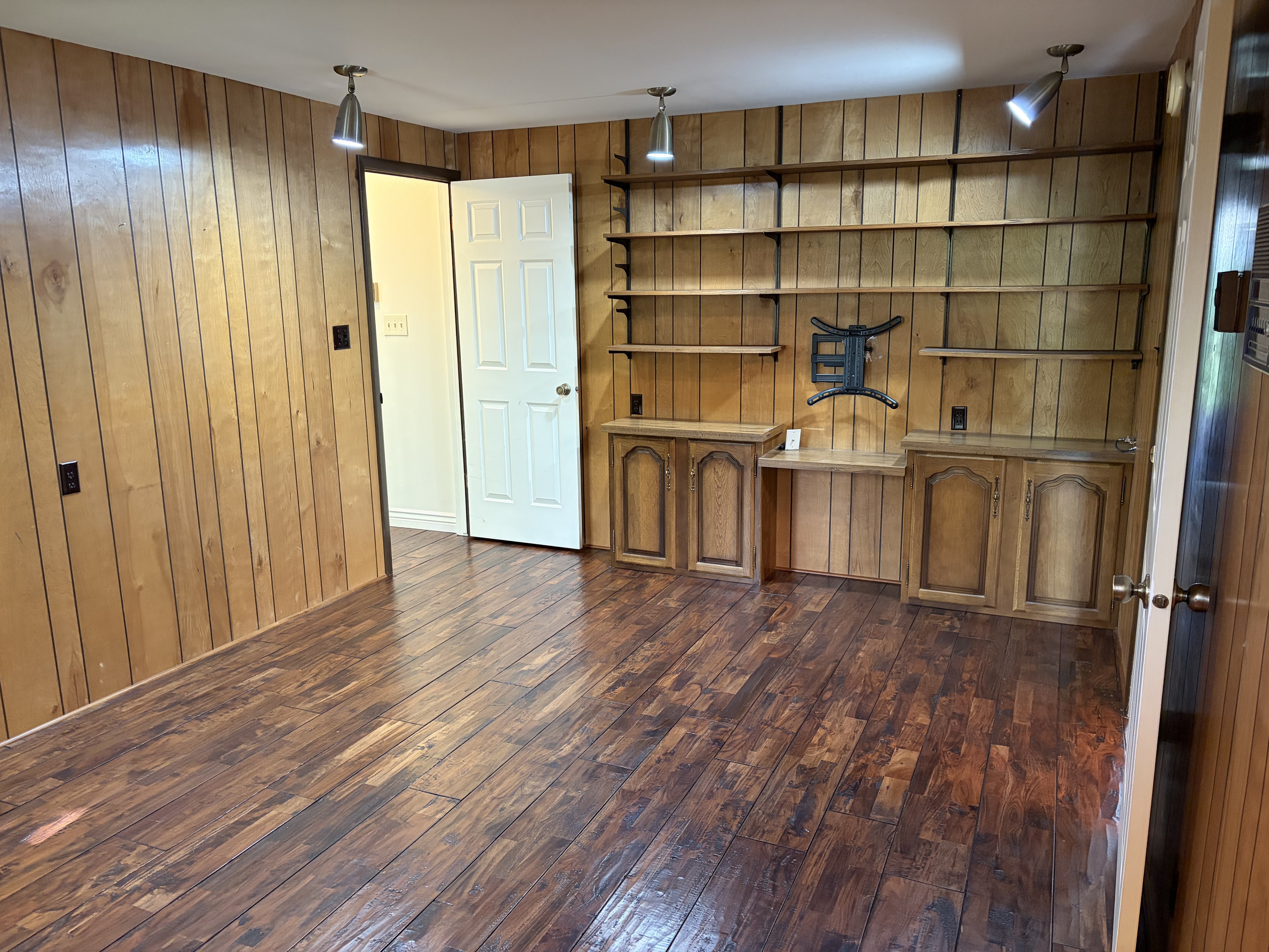 Interior space featuring dark wood-type flooring and wood walls