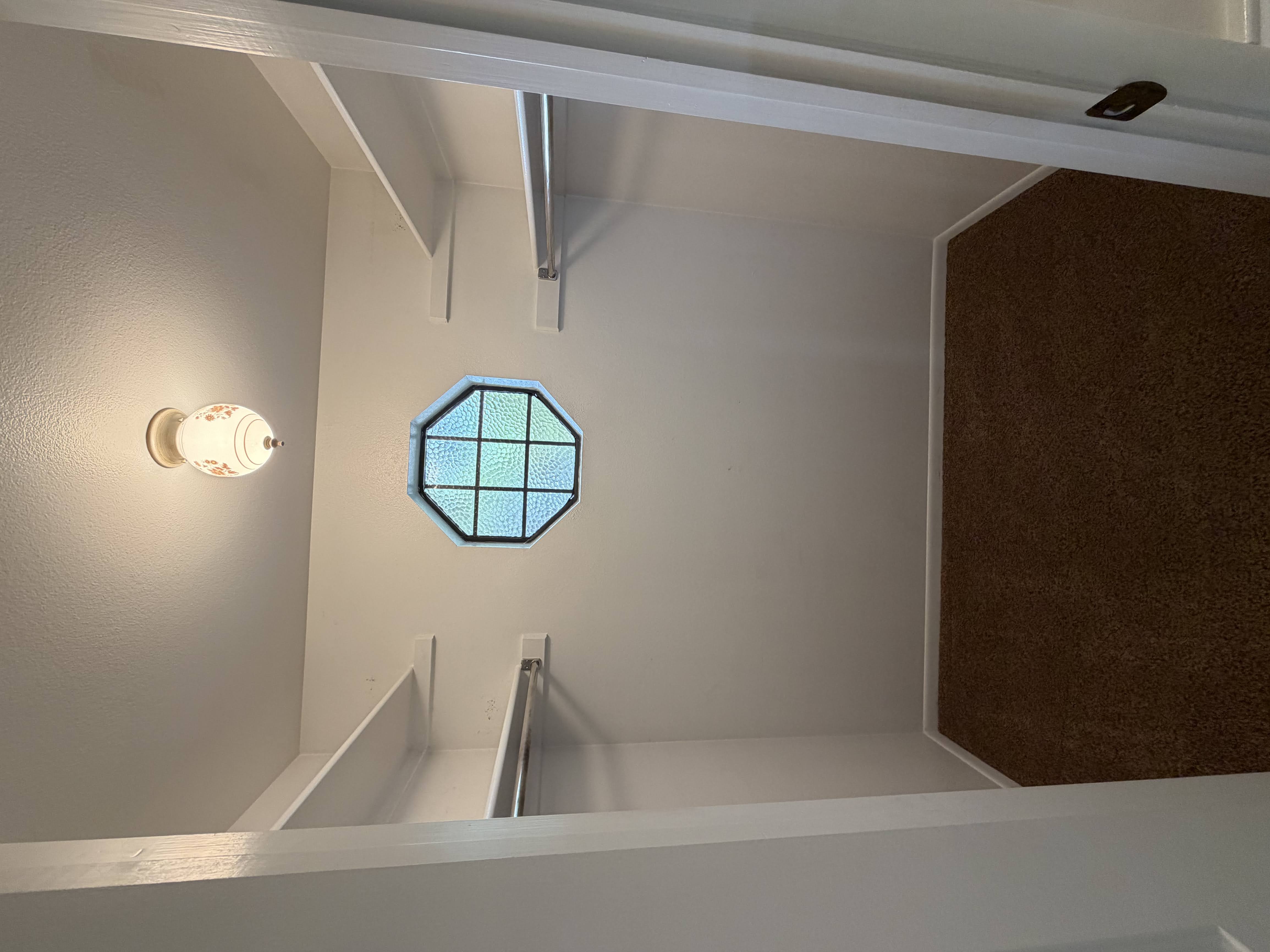 Walk in closet with dark colored carpet