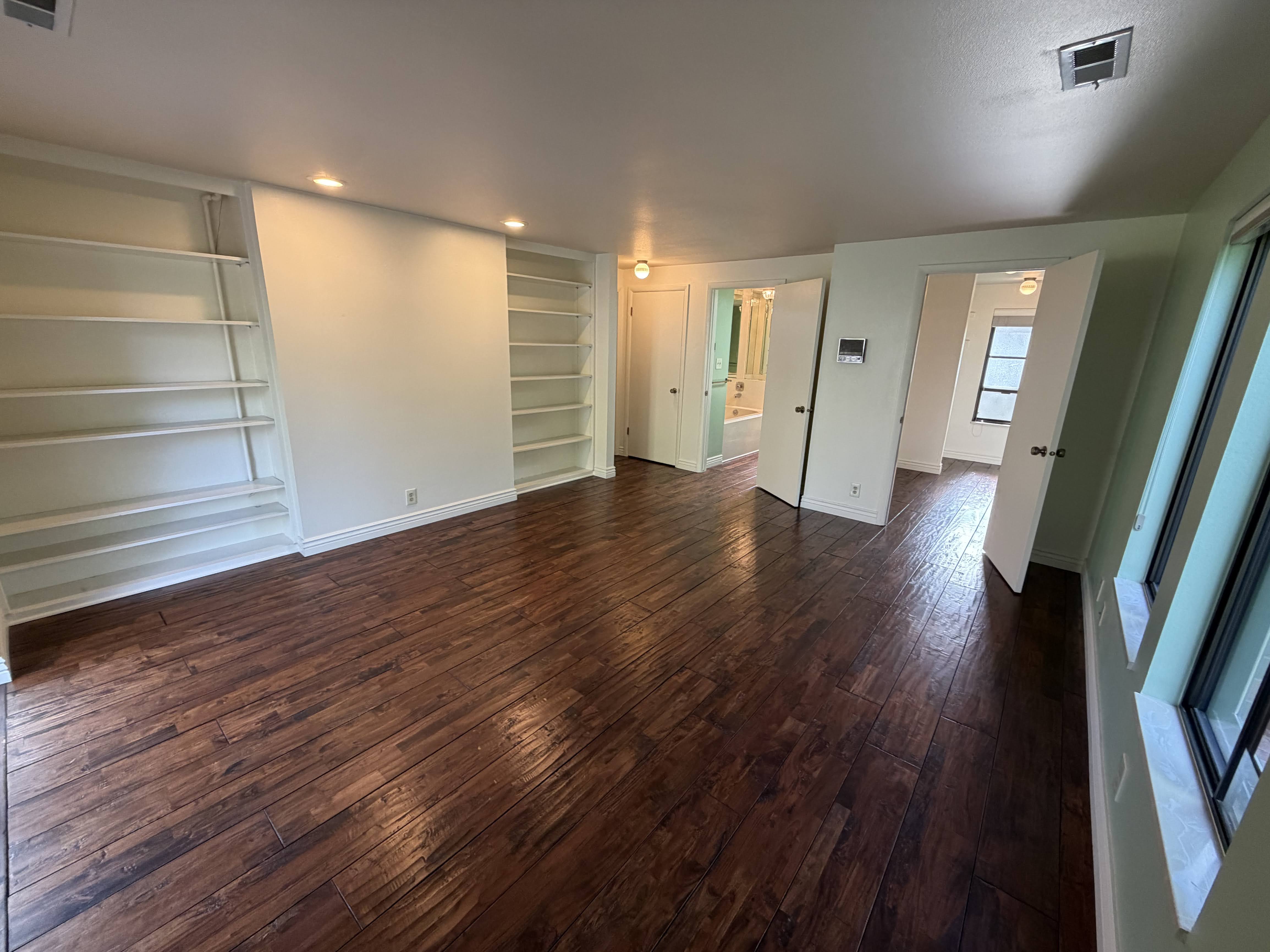 Unfurnished bedroom with dark wood-style flooring and recessed lighting