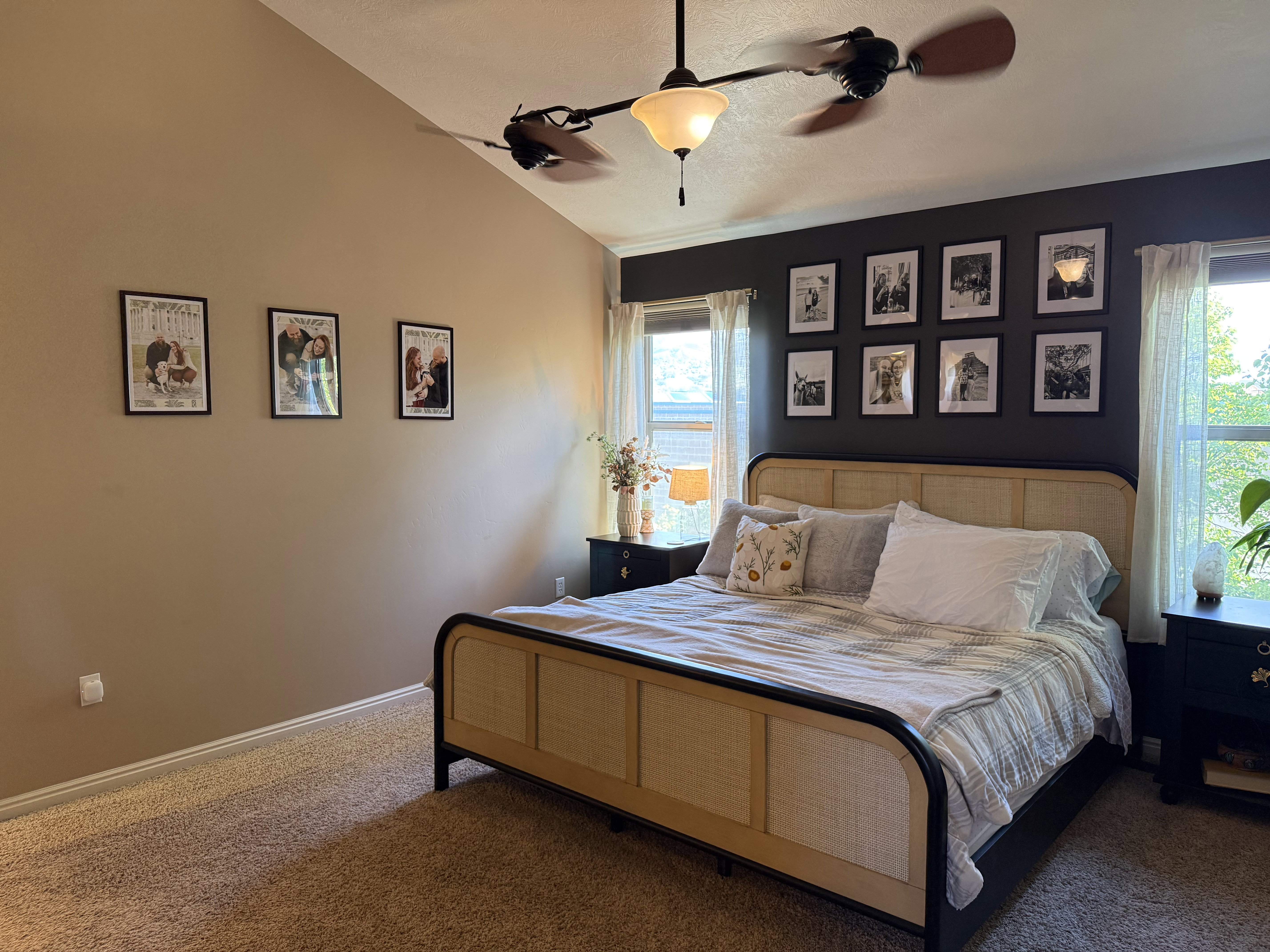 Carpeted bedroom with ceiling fan and lofted ceiling