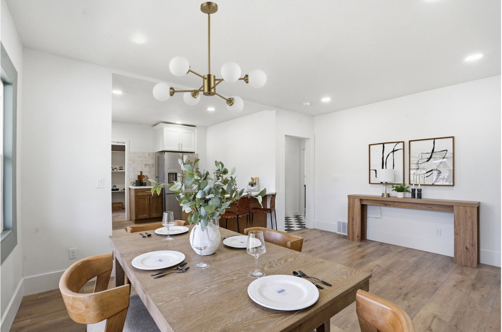 Dining area featuring a modern brass chandelier with globe lights, recessed lighting, and wood-finish flooring