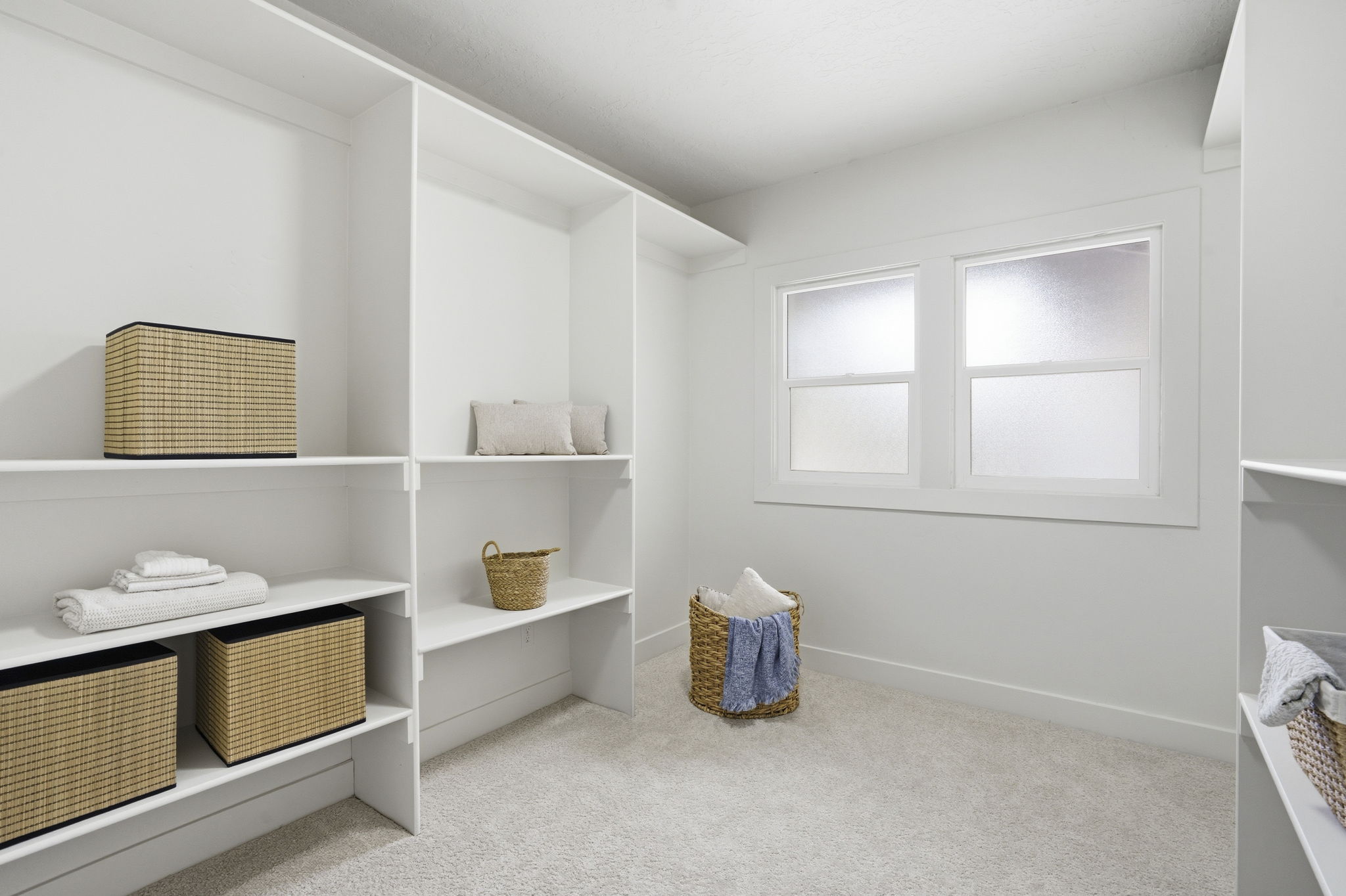 Walk in closet featuring light colored carpet