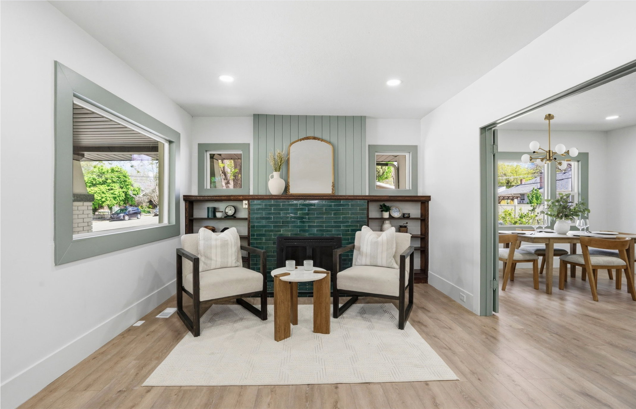 Living area featuring a fireplace with teal tile surround and shiplap accent wall, built-in shelving, light wood-finish flooring, and recessed lighting