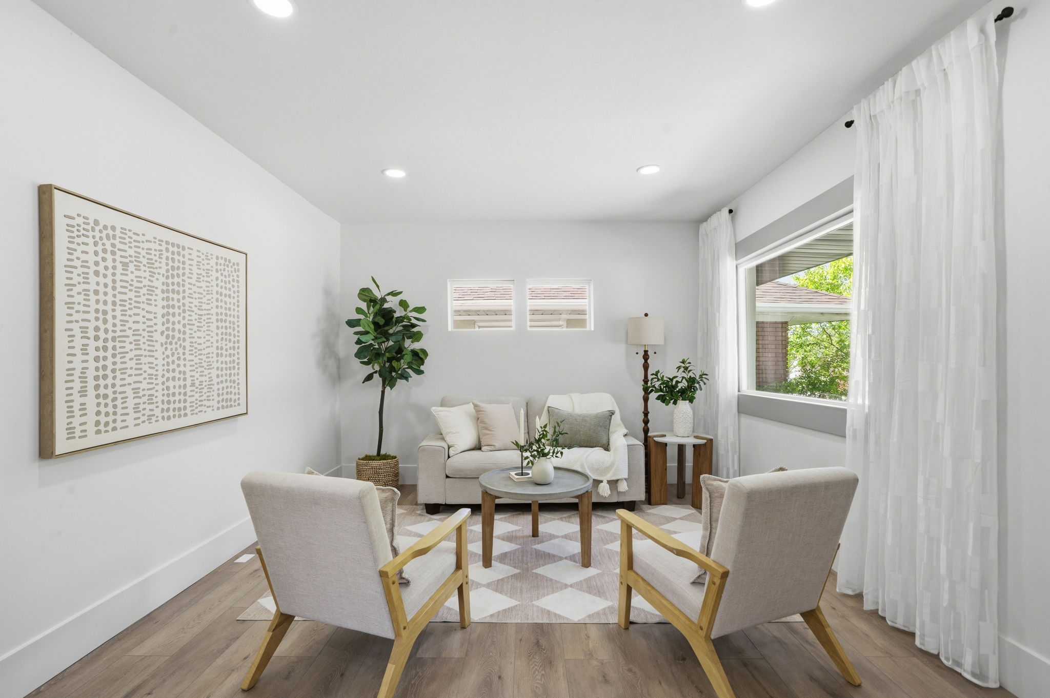 Living area with wood finished floors, plenty of natural light, and recessed lighting