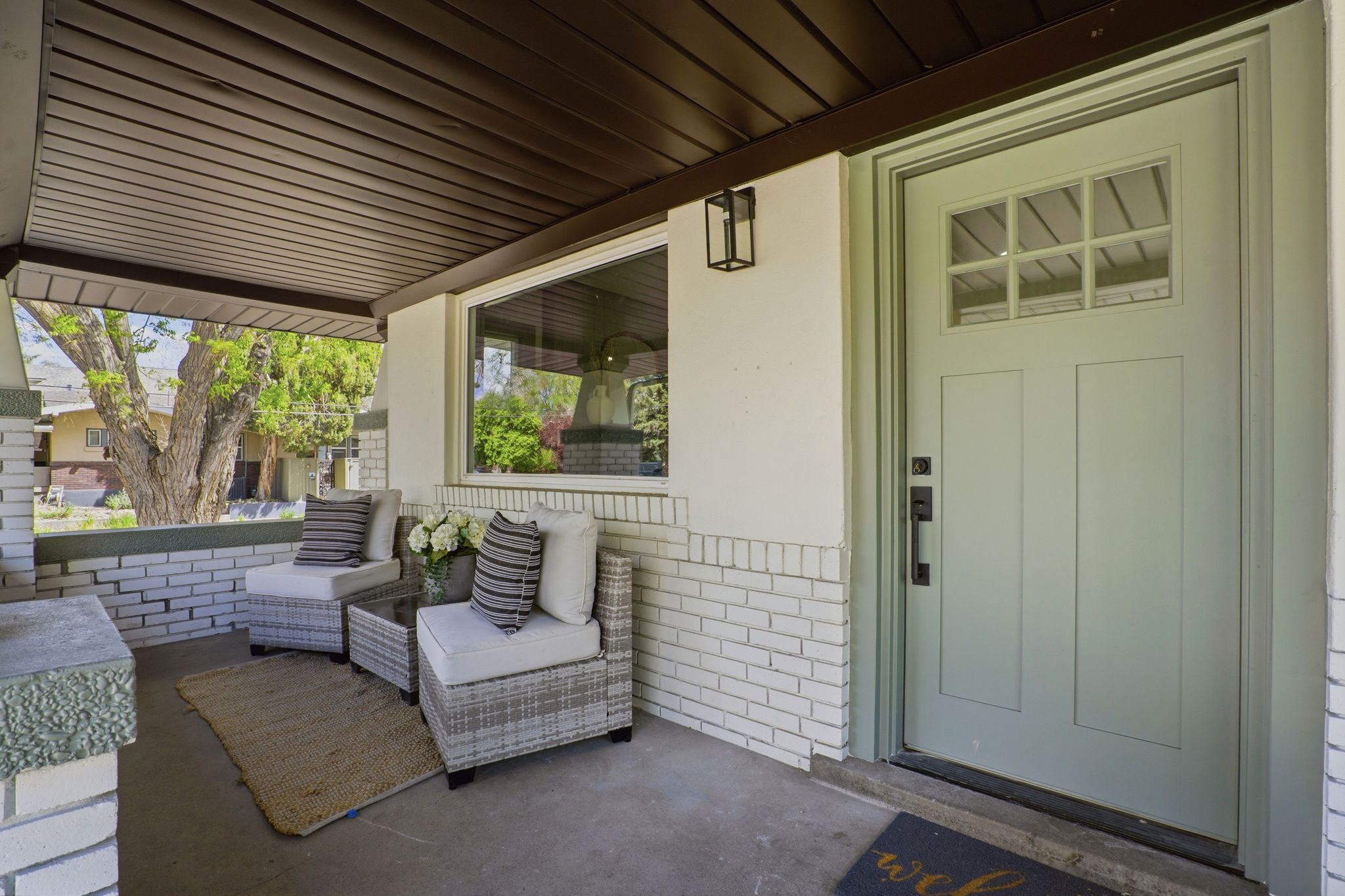 Entrance to property featuring brick siding and a patio