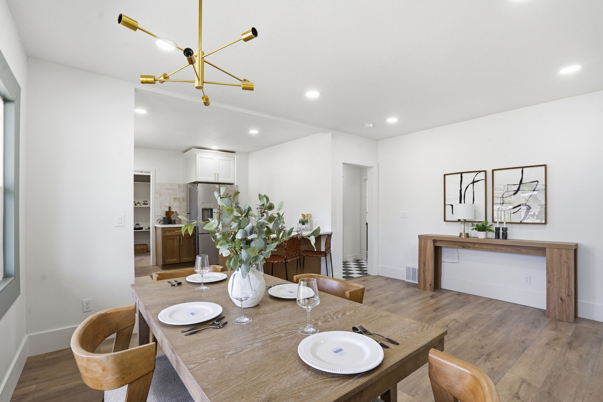 Dining room with light wood-style floors and a chandelier
