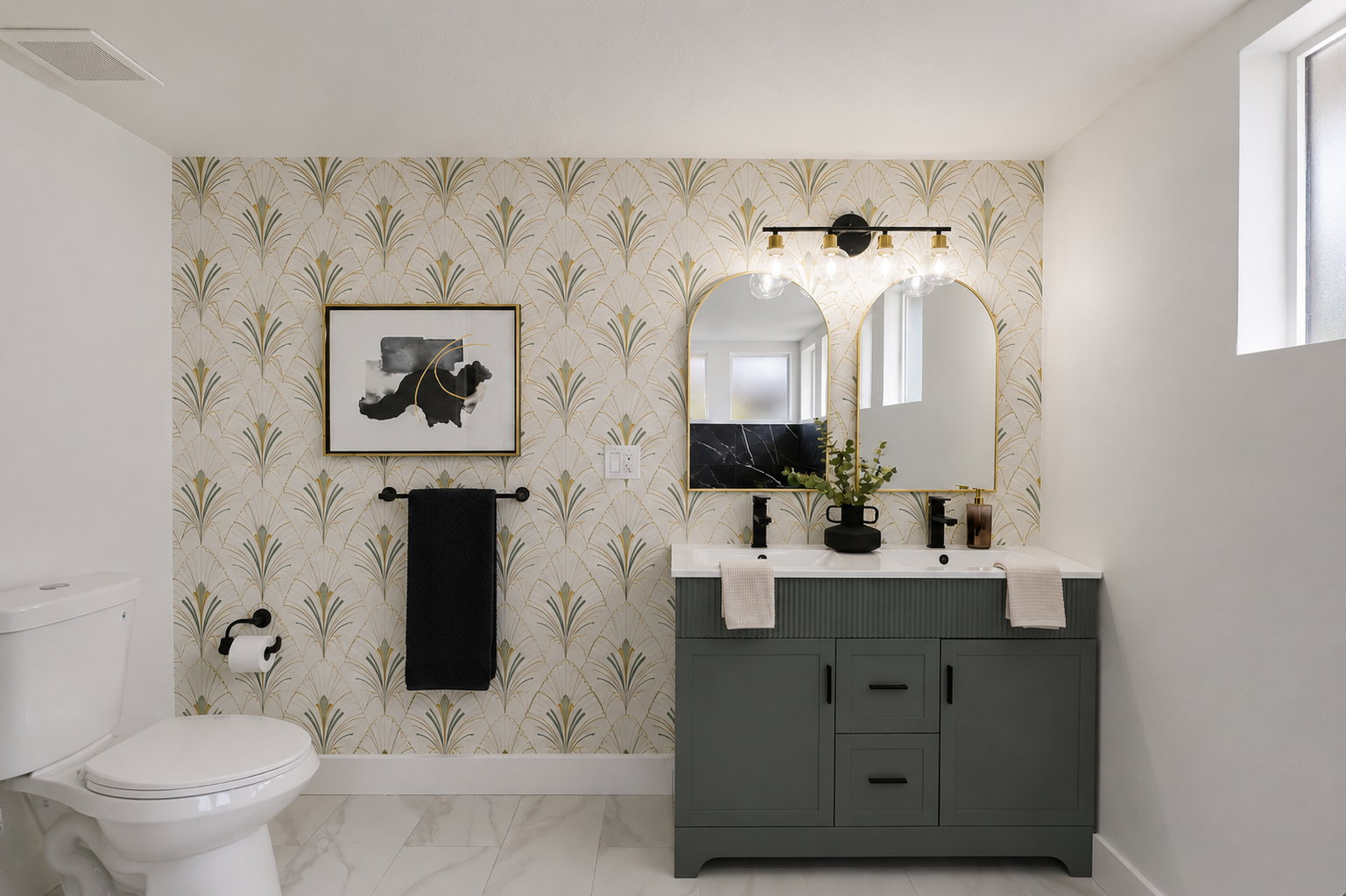 Dual sink vanity with matte black fixtures, gold-framed arched mirrors, and a black marble-look backsplash