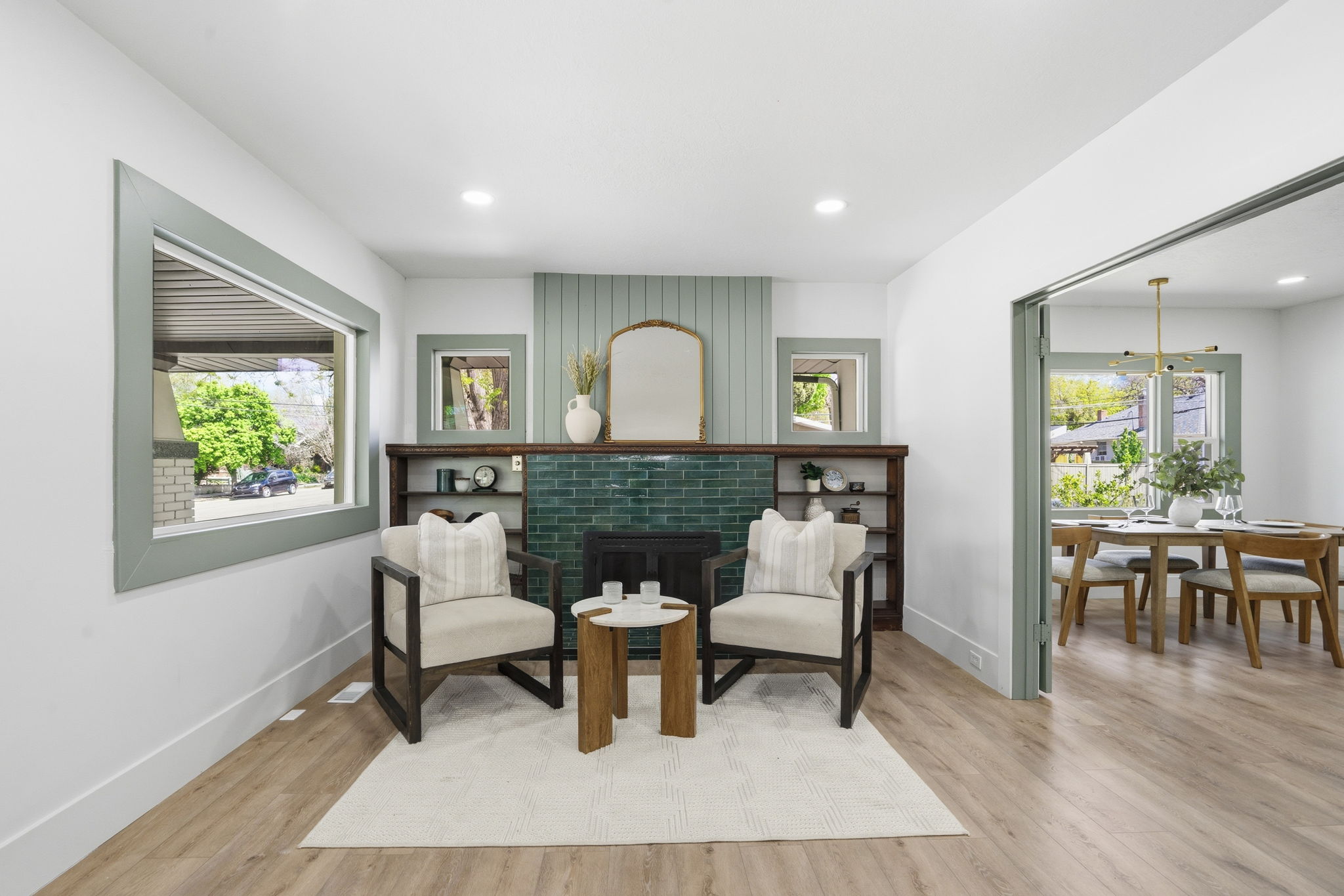 Living area featuring a brick fireplace, light wood-style flooring, and recessed lighting