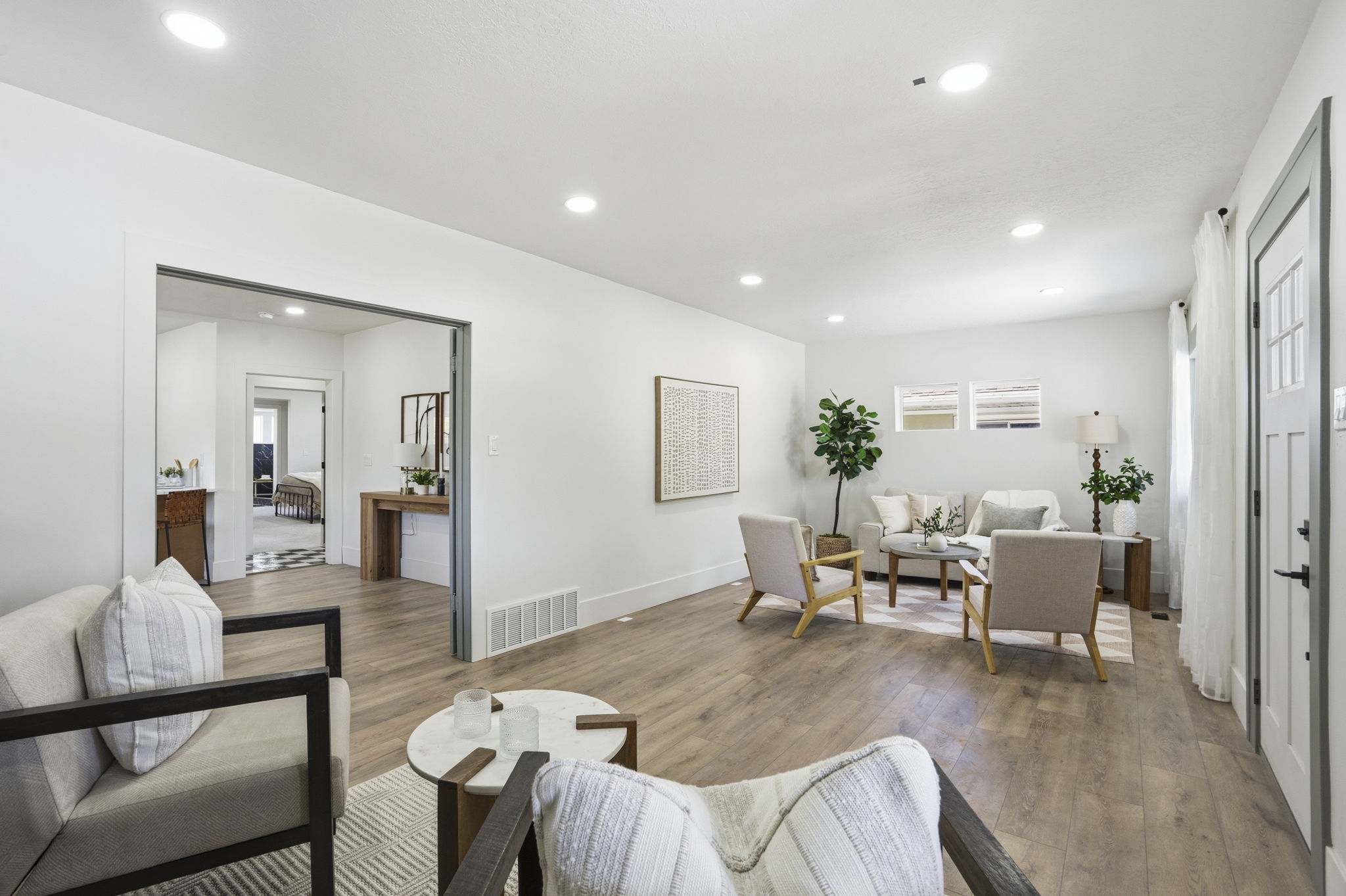 Living area with hardwood / wood-style flooring and recessed lighting