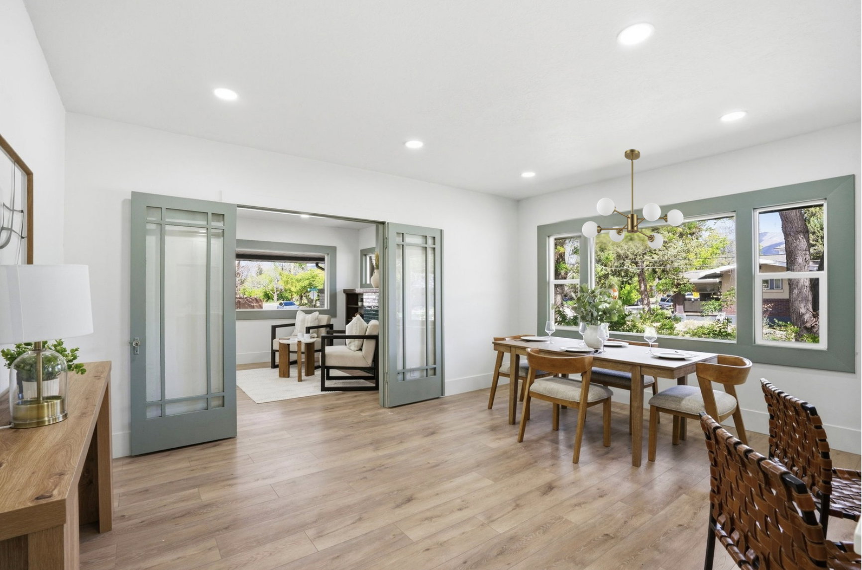 Dining area featuring wood-finish flooring, recessed lighting, and a modern chandelier