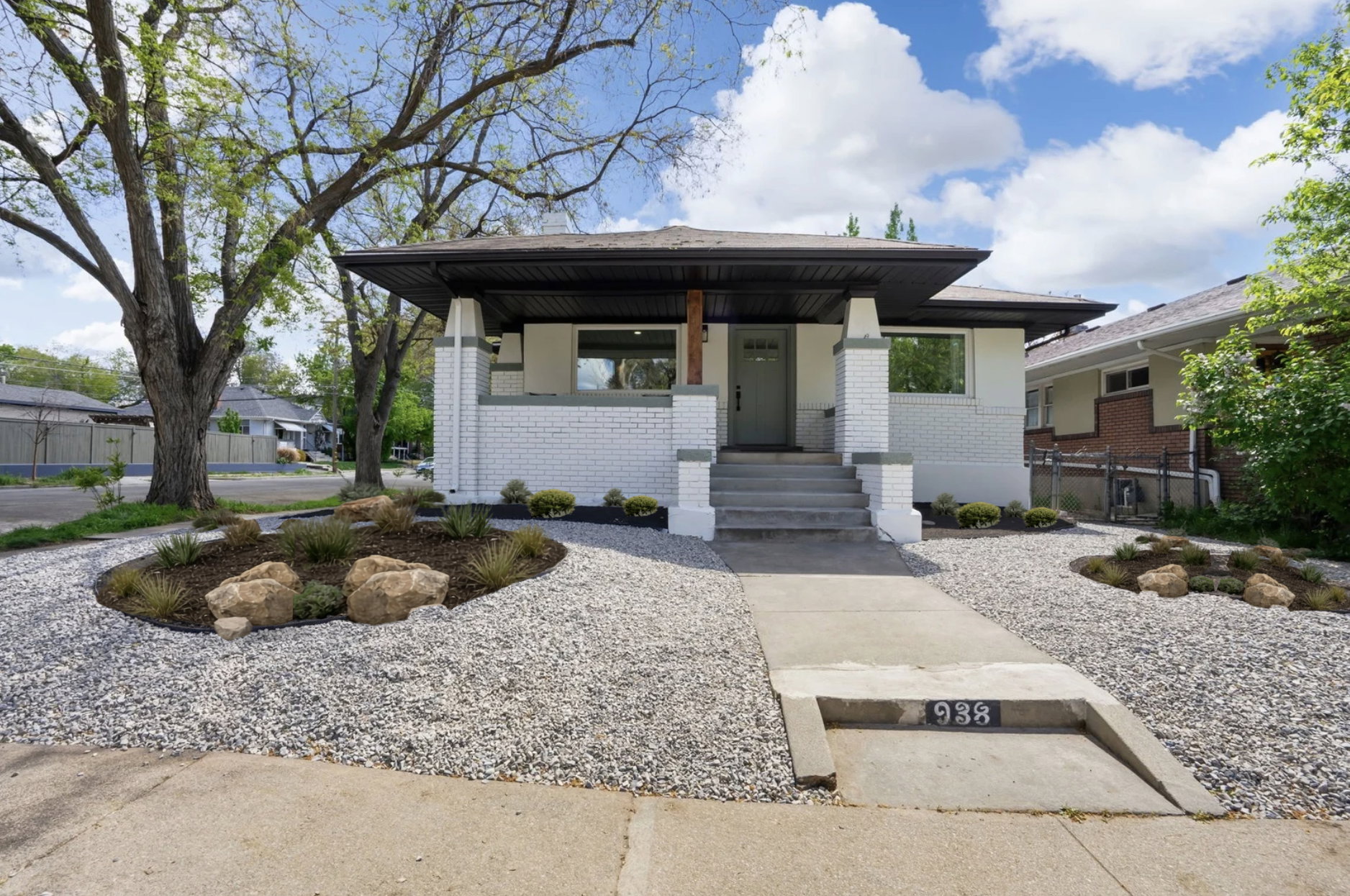 View of front of home with a porch and brick siding