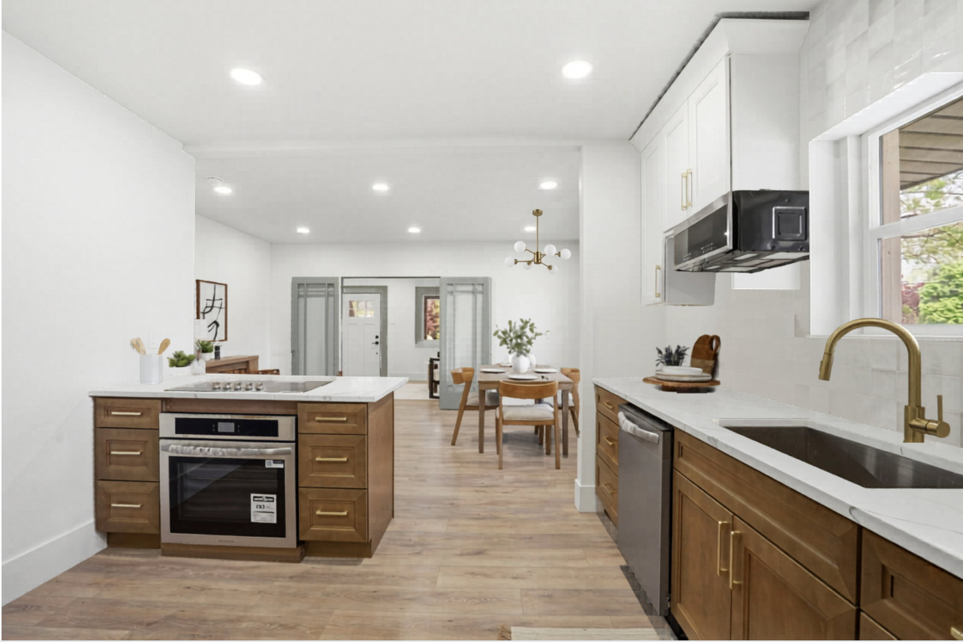 Kitchen featuring light stone counters, stainless steel appliances, light wood-style floors, wood finish cabinetry, and suspended lighting
