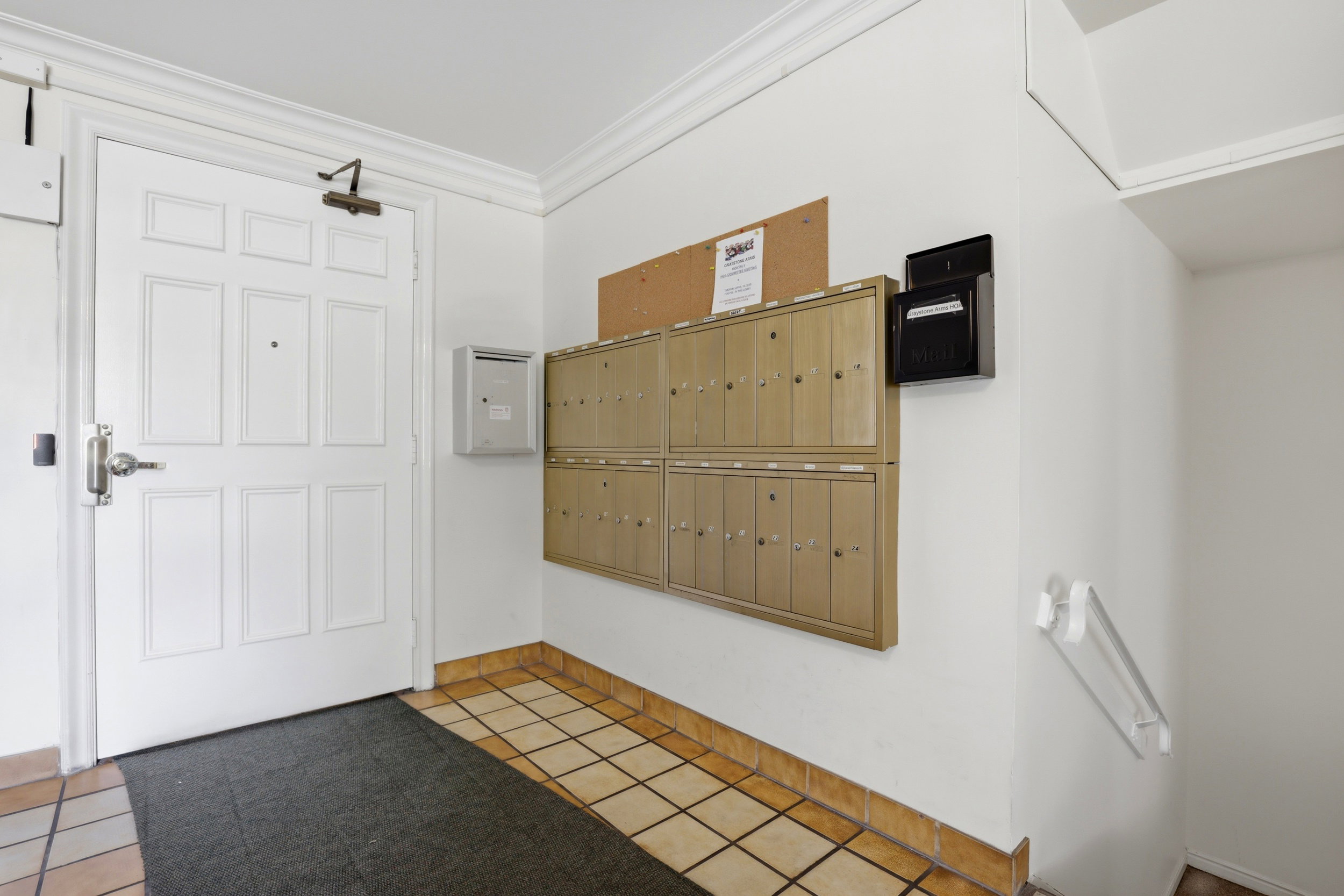 Foyer entrance featuring mail area, ornamental molding, and light tile patterned flooring