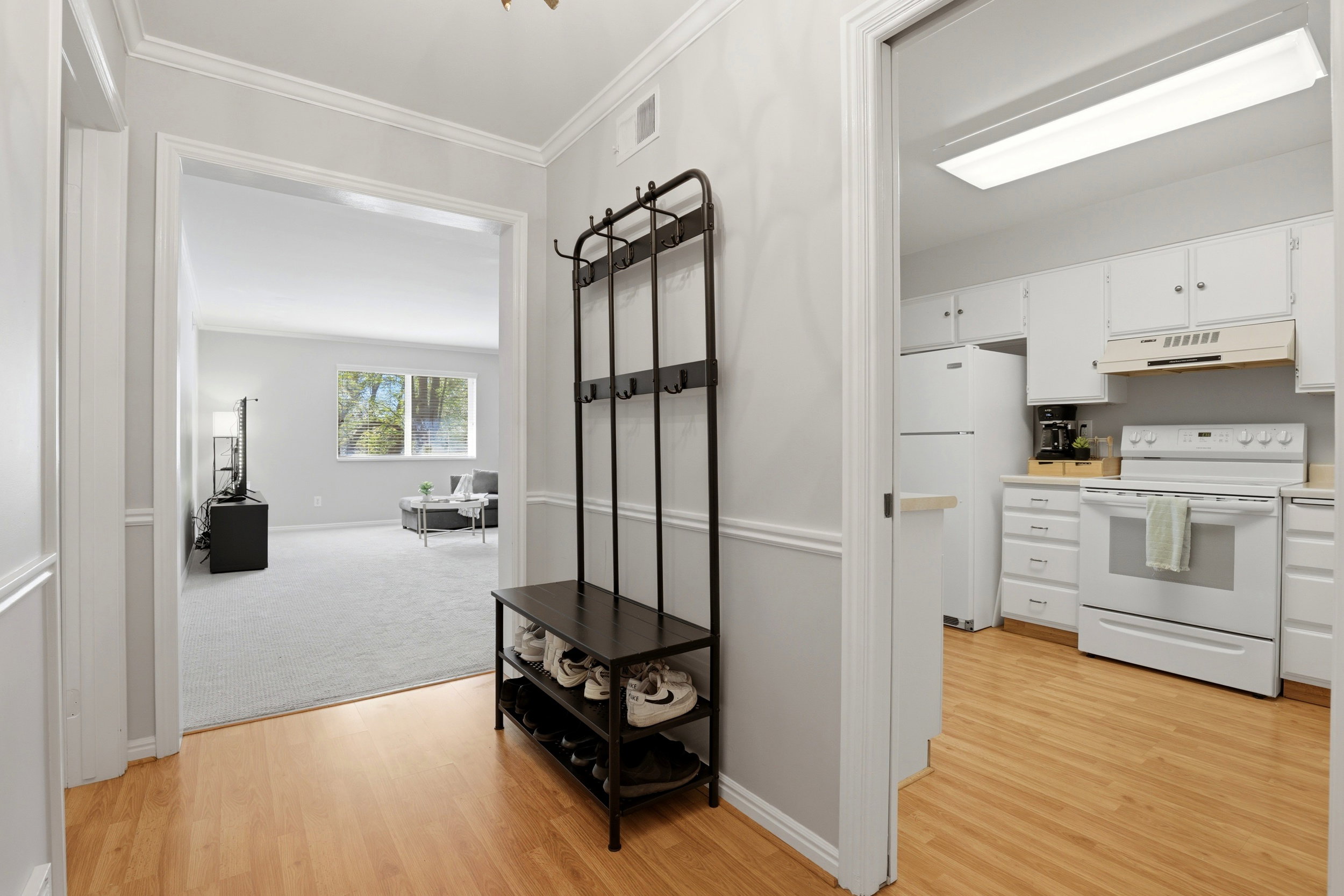 Corridor featuring crown molding and light wood-style flooring