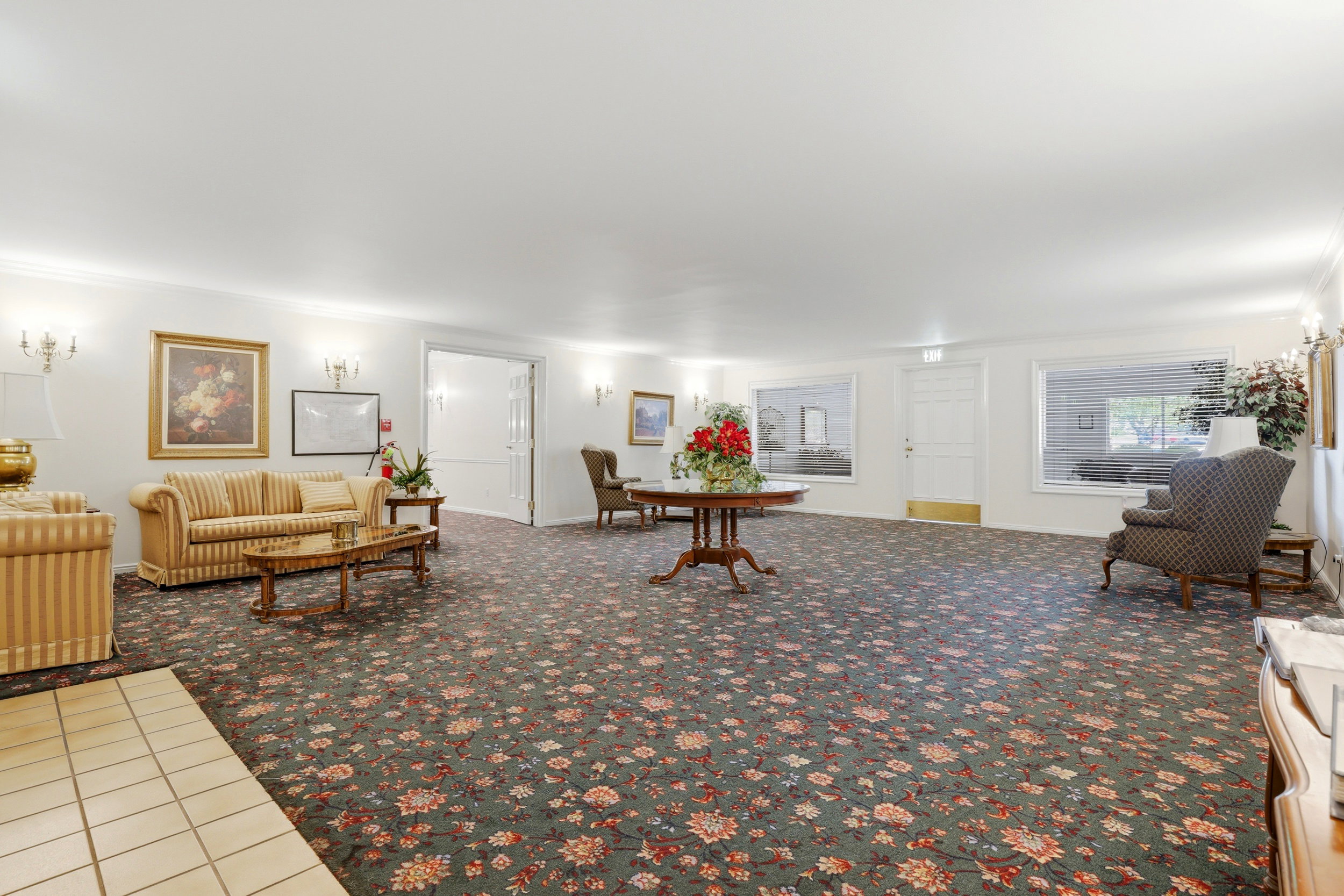 Living room featuring light carpet, crown molding, and light tile patterned flooring