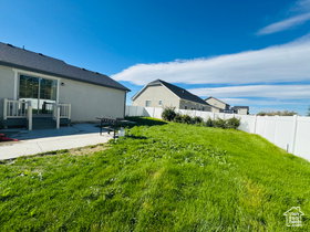 Fenced backyard with a patio