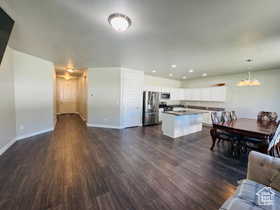 Living room featuring dark wood-type flooring and recessed lighting