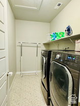 Laundry room with washing machine and dryer and baseboards