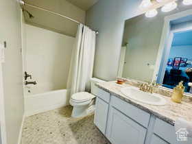 Main bathroom featuring vanity and shower / bath combo