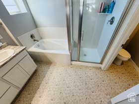Primary bathroom featuring vanity, a shower stall, and a bath
