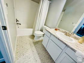 Main Full bath with vanity, shower / tub combo with curtain, and light floors