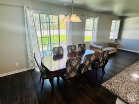 Dining area with baseboards and dark wood-type flooring
