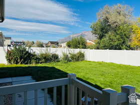 Fenced backyard featuring a mountain view