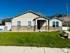 Craftsman-style home featuring an attached garage, stone siding, a porch, and stucco siding