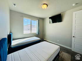 3RD Bedroom featuring baseboards and dark carpet