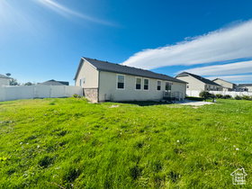 Rear view of house featuring stone siding