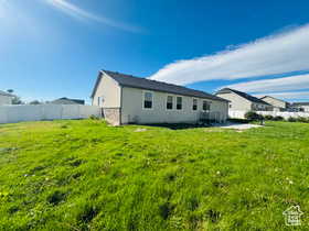 Rear view of house featuring stone siding