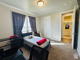 Bedroom TWO featuring light carpet and baseboards