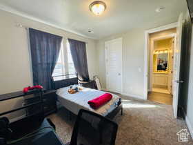 Bedroom TWO featuring light carpet and baseboards