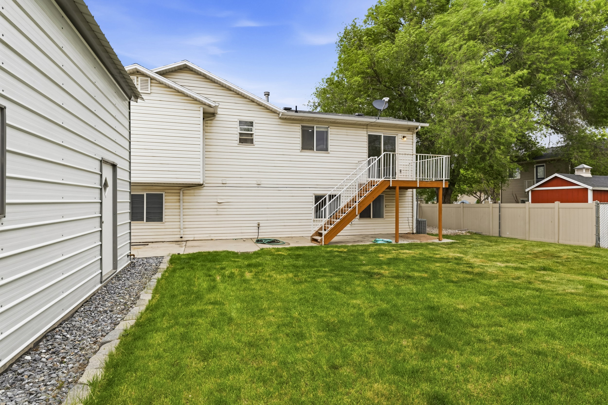 Rear view of property with a wooden deck and a patio area