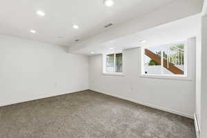 Empty room featuring recessed lighting, carpet, and baseboard heating