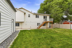 Back of house featuring a deck and a patio area