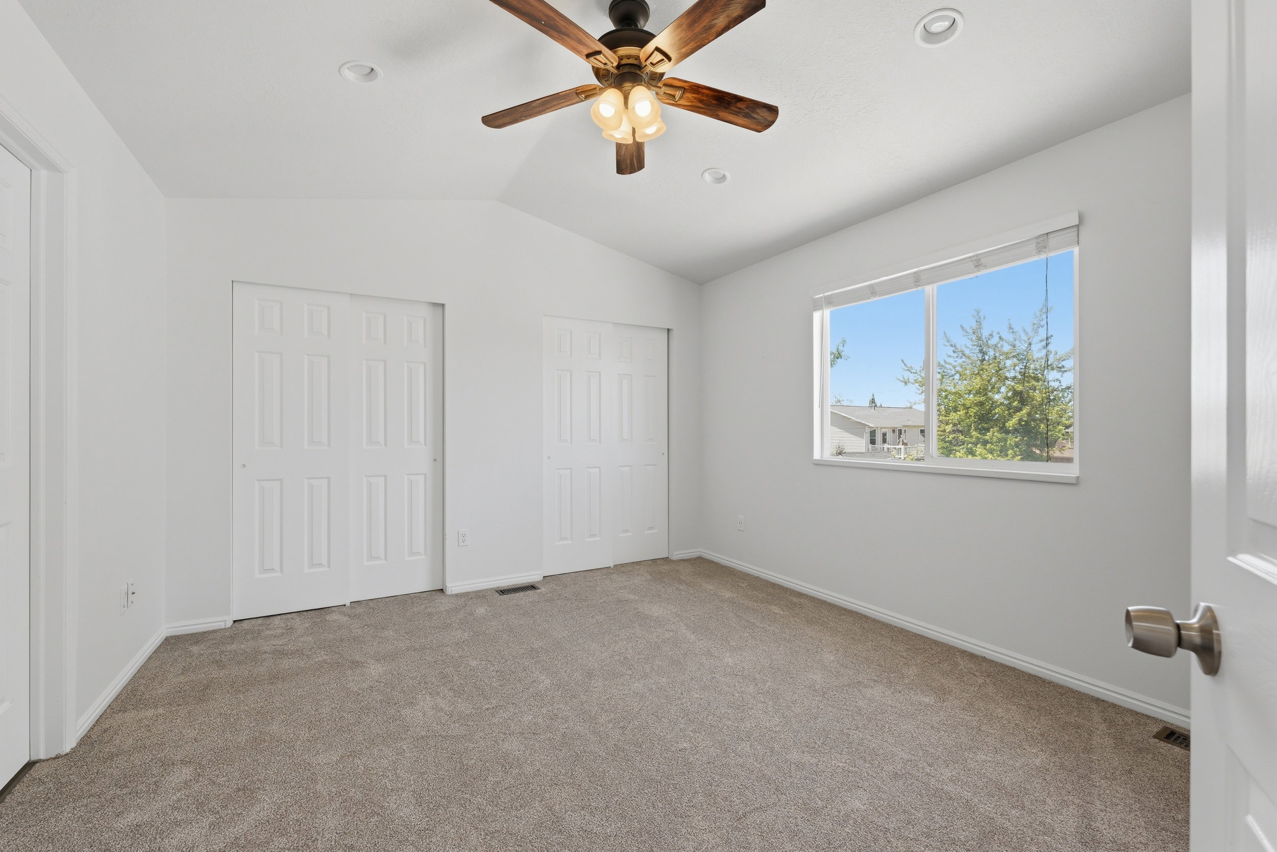 Spacious PRIMARY room featuring vaulted ceilings, recessed lighting, and a ceiling fan