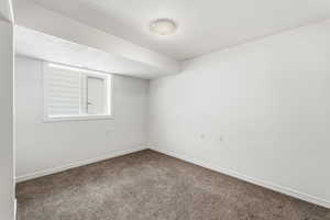 Spare room featuring carpet floors and a textured ceiling