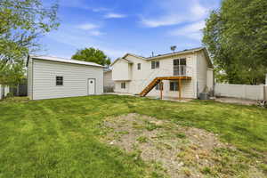 Back of house featuring a metal roof and an outdoor structure