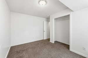 Unfurnished bedroom with carpet floors and a closet