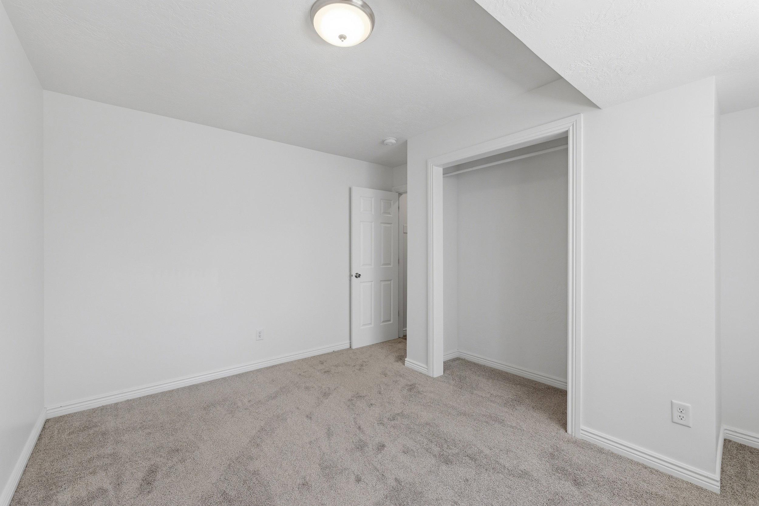 Light gray carpeted flooring paired with white walls