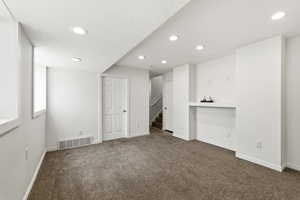 Unfurnished bedroom featuring recessed lighting and dark colored carpet