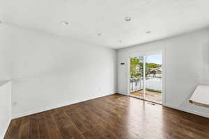 Spare room with dark wood finished floors and recessed lighting