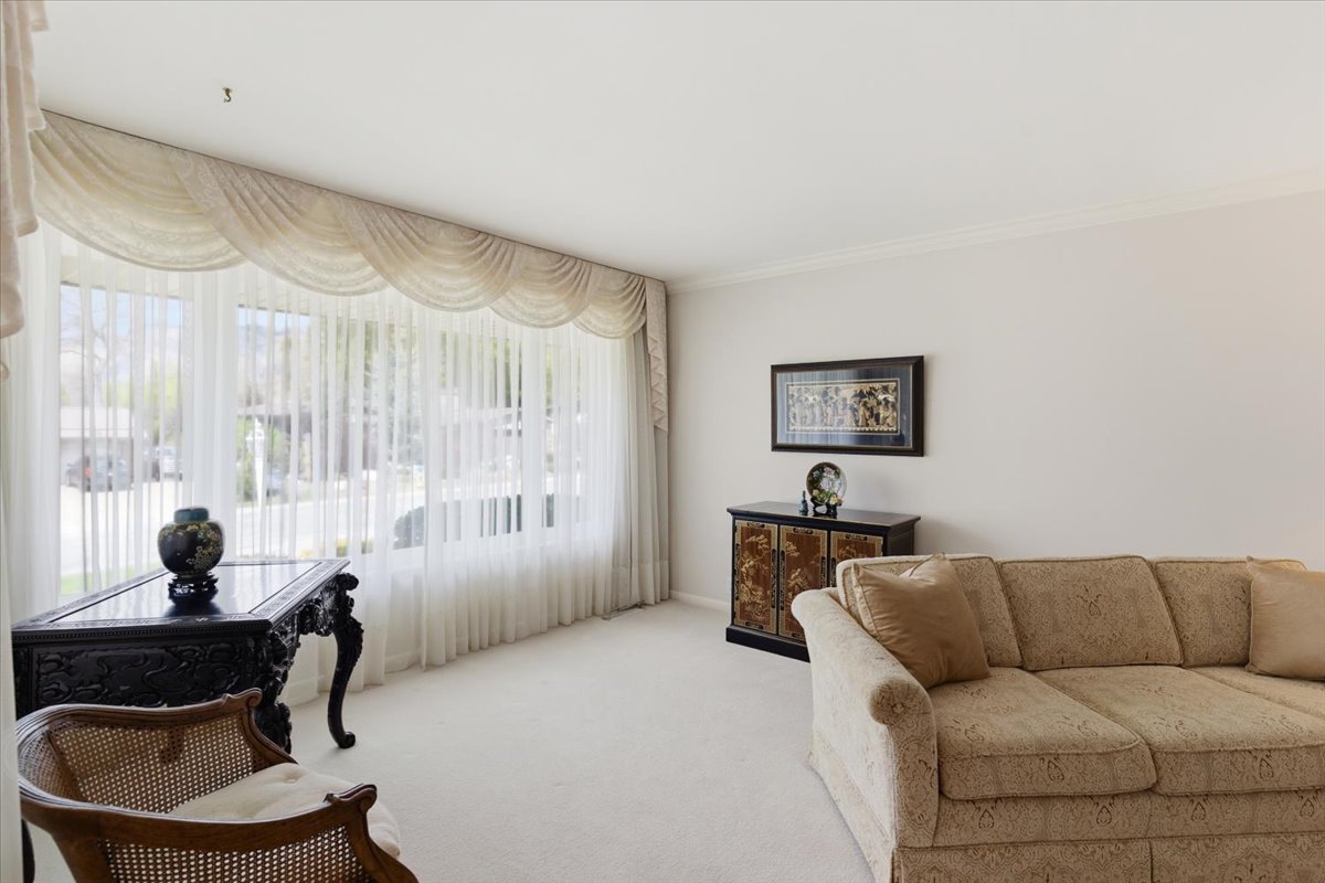 Sitting room with carpet and crown molding