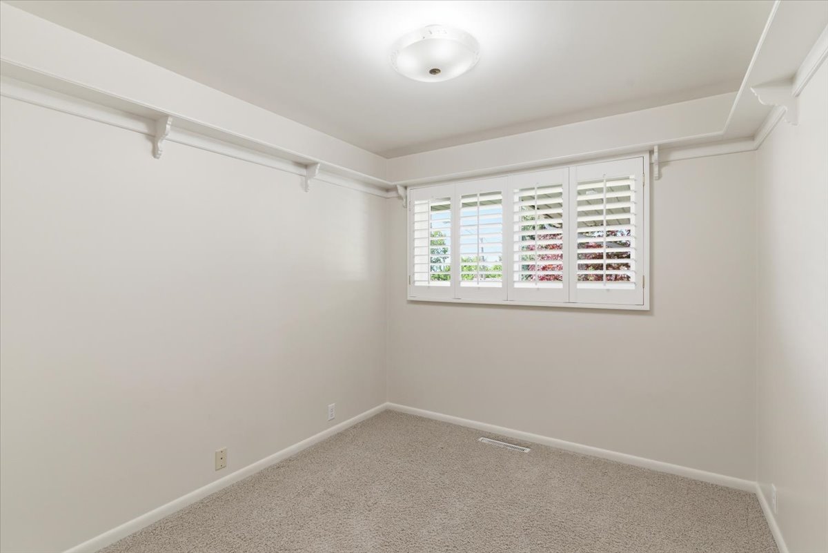 Walk in closet featuring light carpet