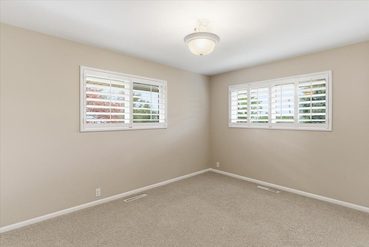 Unfurnished room featuring baseboards and light colored carpet