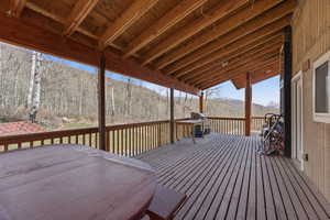 Wooden terrace featuring a grill and a mountain view