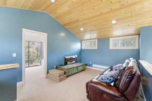 Living area with a vaulted wood ceiling, carpet floors, recessed lighting, healthy amount of natural light, and baseboard heating